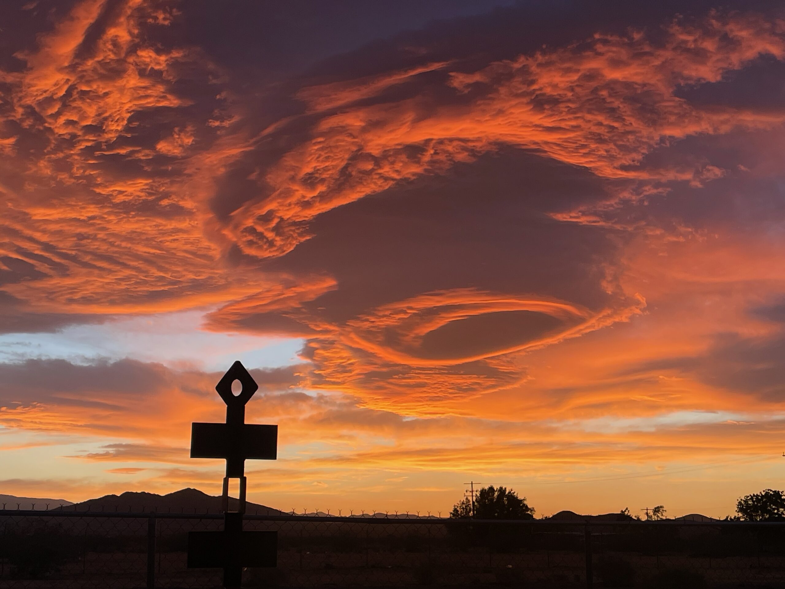 A Simi Dabah sculpture silhouetted against a Joshua Tree sunset